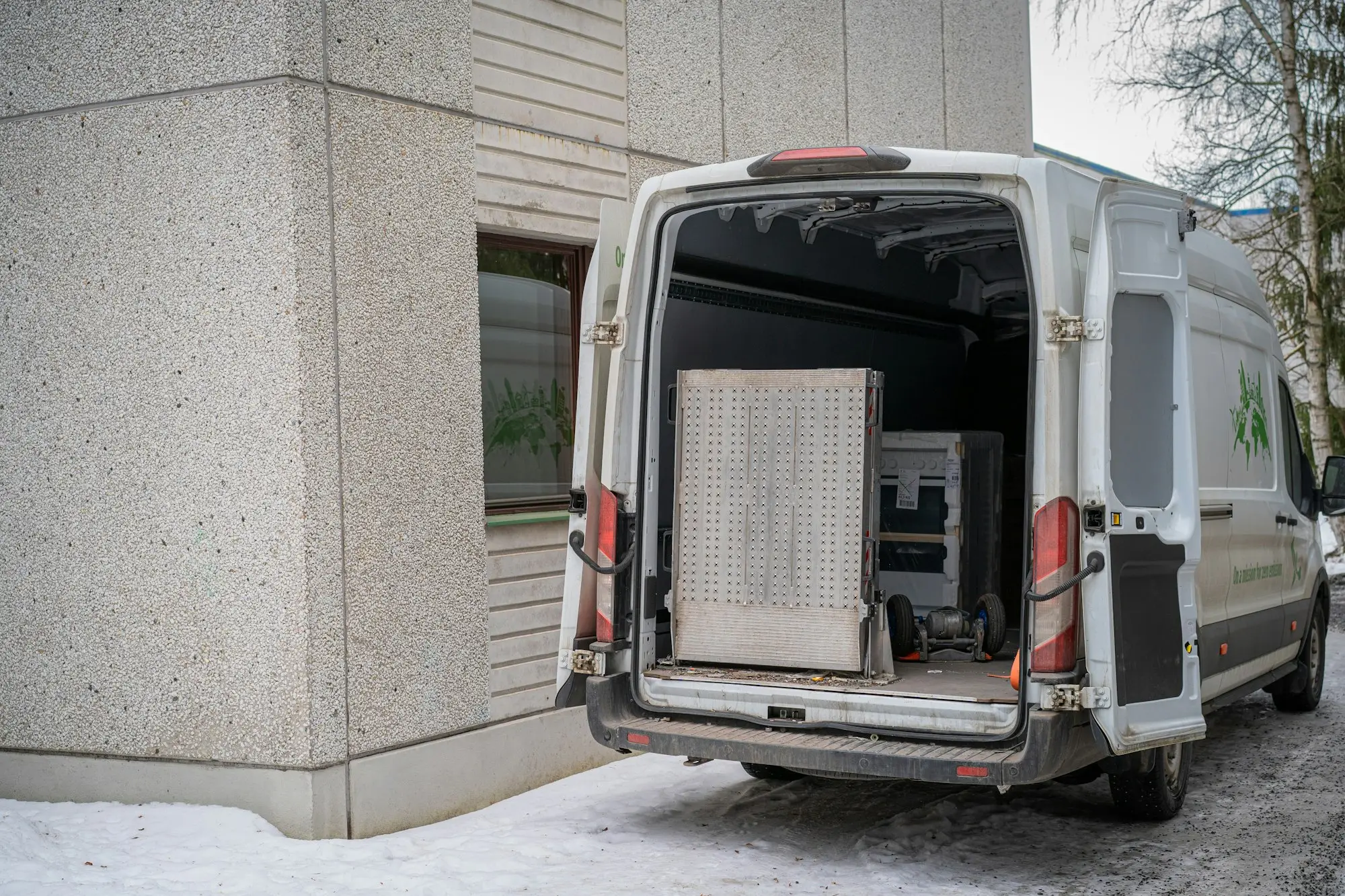 Delivery van with its rear doors open, ready to load stock for a business run