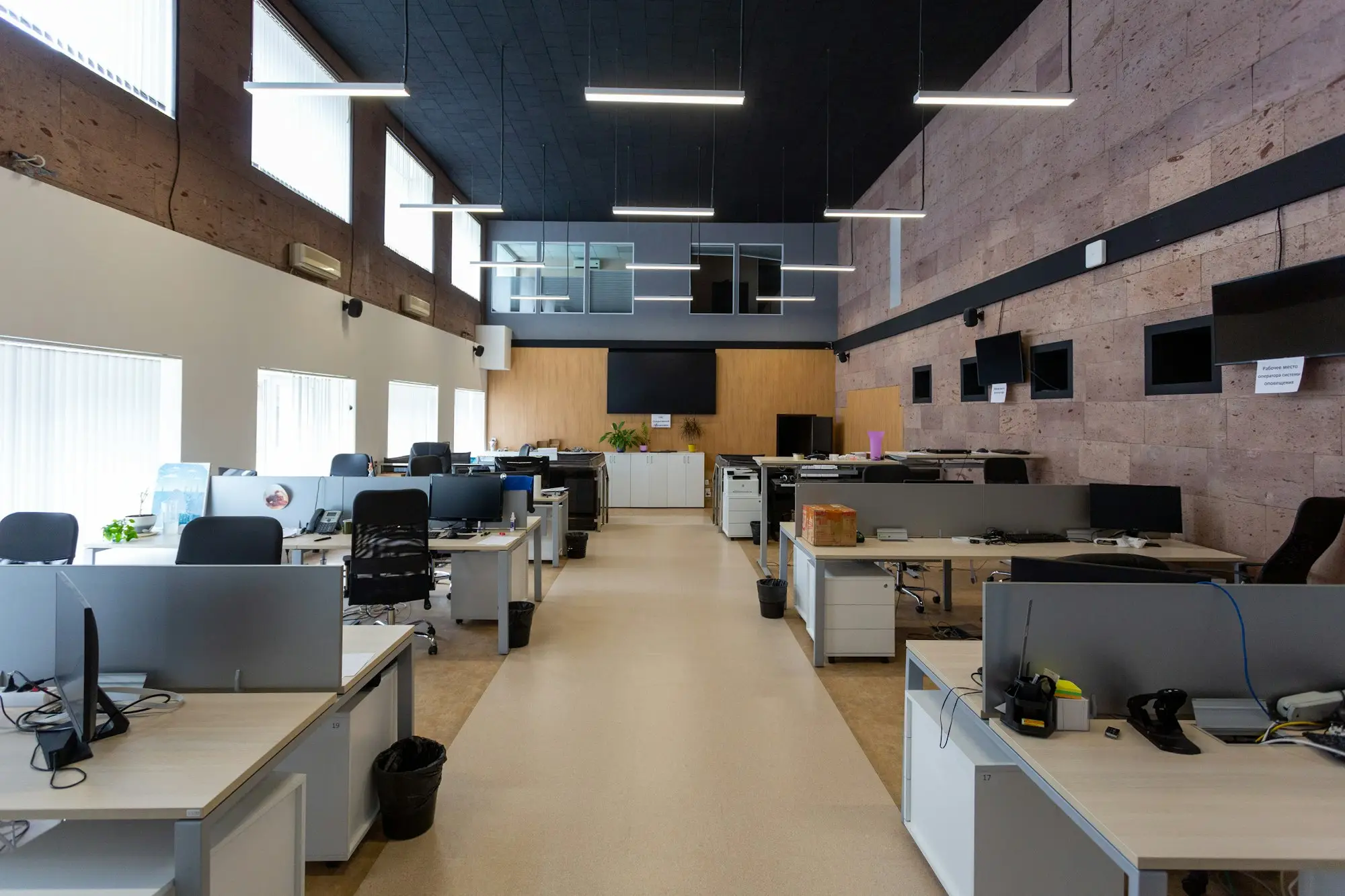 Open-plan office with rows of desks and computers, the IT equipment a growing team needs